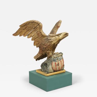 CARVED EAGLE WITH SWEPT BACK WINGS PERCHED ON A ROCK WITH SHIELD