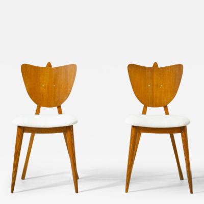 Two oak chairs with padded wooden seat and heart shaped back 