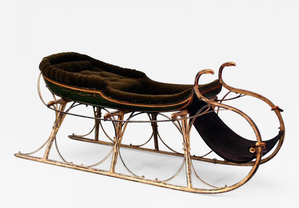 Extremely Fine and Important Child's Sled, with eight carved and gilted eagles. The sled is beautifully polychromed and retains most of its original paint. The sled pulls are ivory and possibly whale's tooth. The sled has a new upholstery green velvet mohair seat. Offered by Hyland Granby Antiques.