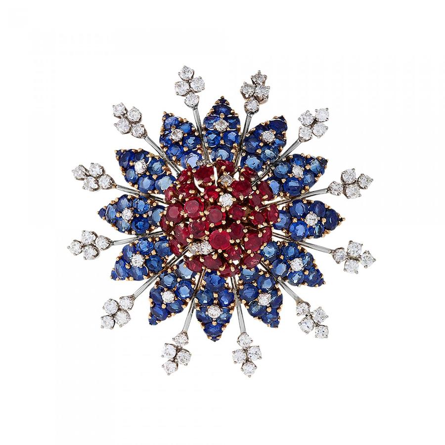 A Mid-20th Century Ruby, Diamond and Sapphire Star Brooch, c. 1945. Platinum and 14 kt gold with rubies, diamonds and sapphires. The stylized and dimensional star brooch has 29 round-cut rubies with an approximate total weight of 6.75 carats, 64 round-cut diamonds with an approximate total weight of 4,60 carats, F-G color, VS-SI clarity, and 84 round-cut sapphires with an approximate total weight of 20.75 carats. Offered by Macklowe Gallery.