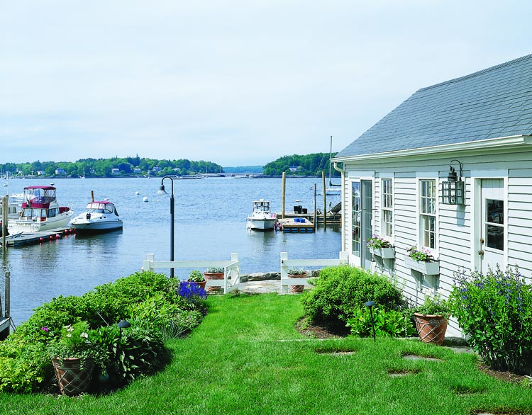 Gardens lead to the water in front of this coastal residence. The couple’s boathouse is on the right, where it serves as a playroom for their five grandchildren. Their dock, to the left, leads to a deep water mooring.