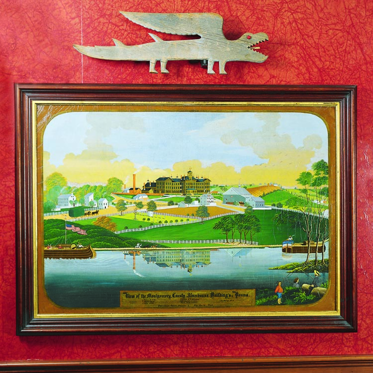 A View of Montgomery County Almshouse (in Pennsylvania) by Charles Hoffman (1821– 1882) hangs in the couple’s office. It was purchased from dealer Fred Giampietro after the couple saw a photograph of the painting. “I asked if it was as good in reality as it appeared in the image,” says the husband. “Fred said it was, so I purchased it on the spot because it was such an important and visually striking painting.” The couple’s first weathervane is placed above the painting.