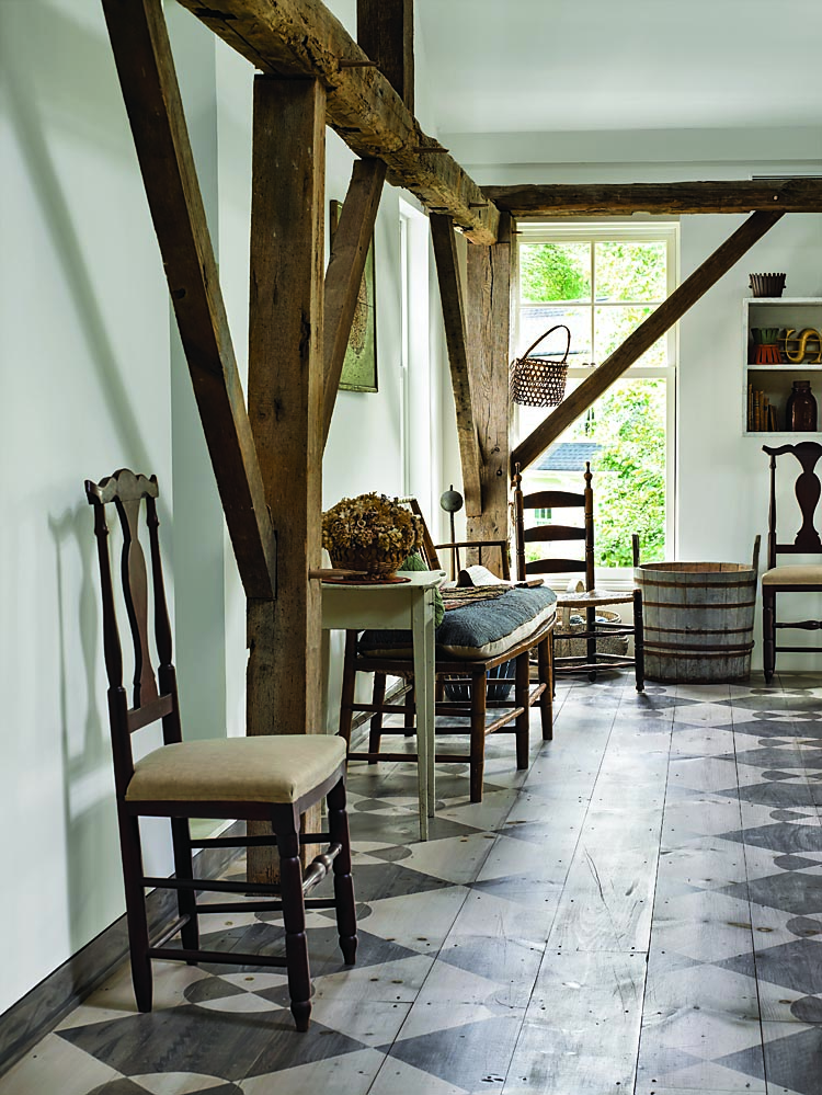 Lining the second-floor sitting room are more of the set of six Connecticut side chairs in the collection and a Windsor bench with original rush seat. The hand-painted floor is by contemporary artist and historic painter David Wiggins, who painted a number of floors and the main staircase in the house, fashioning them on period surfaces.