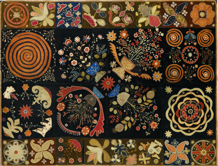 “It’s one of my favorite pieces. I love the imaginative, freeform design and the color scheme,” Grace Snyder says of the circa 1810–20 pieced and embroidered wool-on-wool with silk applique New England table rug, which hangs over the bed in the master bedroom.