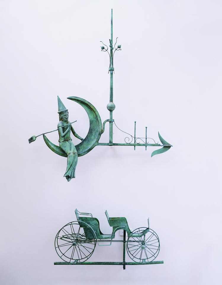 Shown here are two of three particularly fine weathervanes that line the upper staircase wall. A witch seated on a crescent moon is one of only two such examples known. In 1981, when Robert Bishop illustrated the other example in his Gallery of American Weathervanes and Whirligigs he was aware of no others. Below it is a surrey weathervane manufactured by A.B. & W.T. Westervelt of New York, circa 1880. Not shown is a highly sought after J. Howard copper and zinc steer weathervane, circa 1860, purchased from Julie Lindberg.