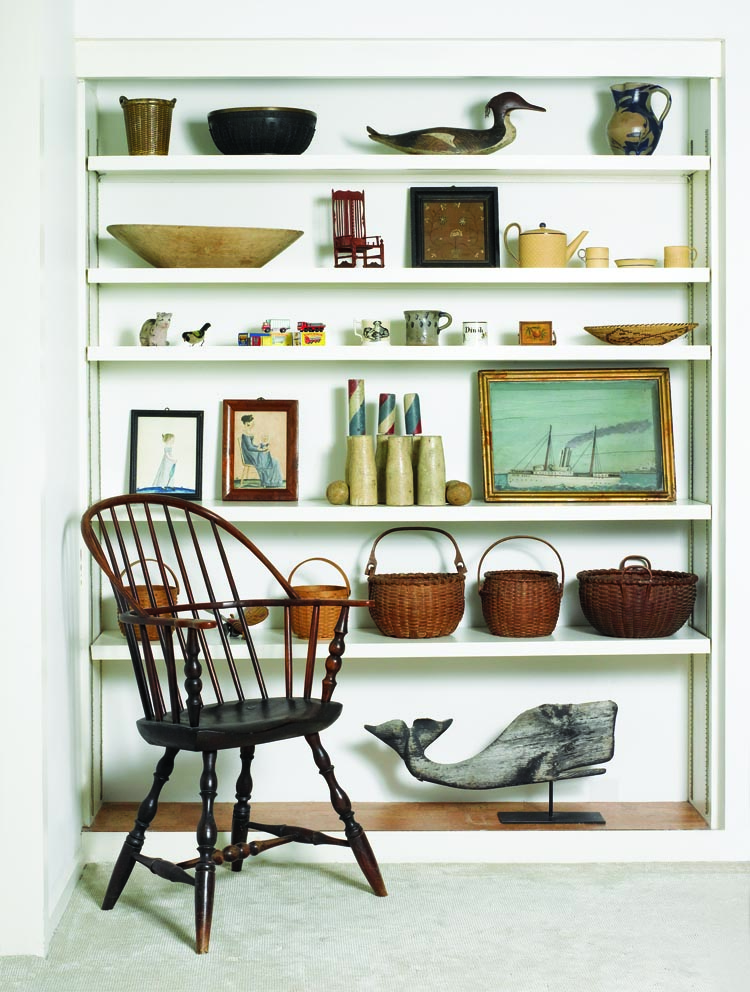 “I love Jacob Maentel watercolors,” says the wife. Two portraits by the early-19th-century itinerant artist who frequently worked in Pennsylvania are pictured center left. Shelves in the couple’s study also display baskets, a folk-art diorama of the ship New York, a merganser decoy, and a primitive wooden whale weathervane said to be from Nantucket.