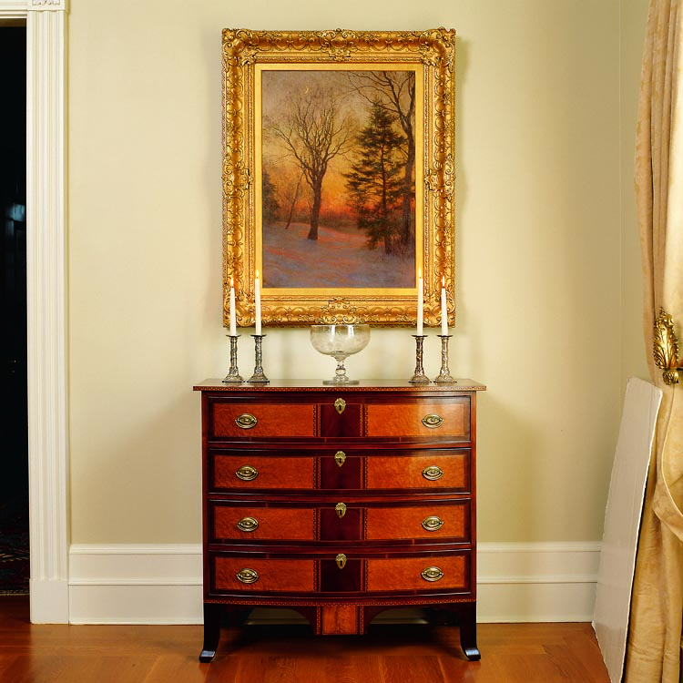 In the gallery, a circa 1790–1810 bowfront drop-panel chest of mahogany with contrasting bird’s-eye maple drawer fronts is attributed to Ephraim Mallard of Gilmanton, New Hampshire. The moonlit view above is by Walter Launt Palmer (1854–1932), an Albany, New York, artist who was the son of sculptor Erastus Dow Palmer. Harmonizing with the winter landscape’s frosty sheen are Chinese silver candlesticks and an engraved Pittsburgh glass compote.