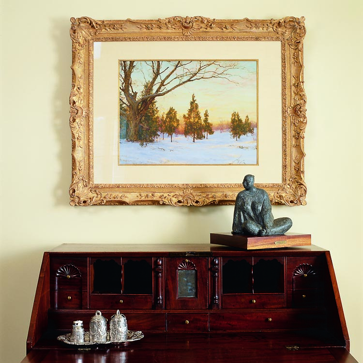 From Boston or Salem, Massachusetts, the circa 1780 Chippendale mahogany reverse-serpentine slant-lid desk on ball-and-claw feet opens to reveal a shell-carved and mirrored prospect door. The pastel above the desk is a rare Greenwich view by Walter Launt Palmer (1854–1932). The bronze seated figure of a woman is by contemporary Mexican artist Armando Amaya.