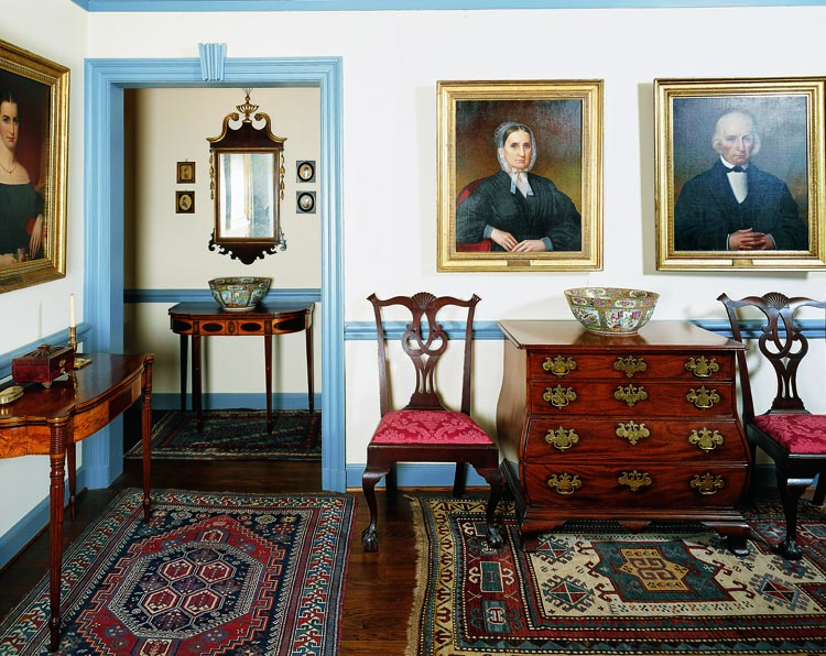 The upstairs sitting room contains the second of two bombé chests in the collection, this one from Wayne Pratt. It is flanked by a pair of circa-1780 Chippendale side chairs attributed to Eliphalet Chapin (1741–1807) and Aaron Chapin (1753–1835), of East Windsor, Conn. The pair is from the same set now in the Garvan Collection at Yale. They were once owned by Jess Pavey and were brought to the couple by Wayne Pratt; a serendipitous connection between the two dealers and the clients. The Federal oval-inlaid card table was made in New York; the other is either from Boston or Salem, Mass. The three portraits are of members of the husband’s family, painted by John Inscoe Williams of Cincinnati, Ohio.